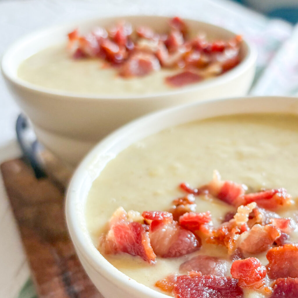 Close-up of Leek and Potato Soup with bacon bits, showing smooth texture and rich, hearty topping.