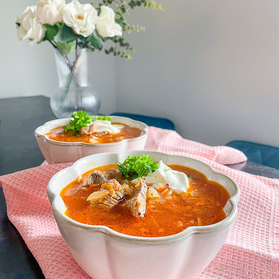 Shchi soup recipe — hearty Russian beef and sauerkraut soup with sour cream garnish