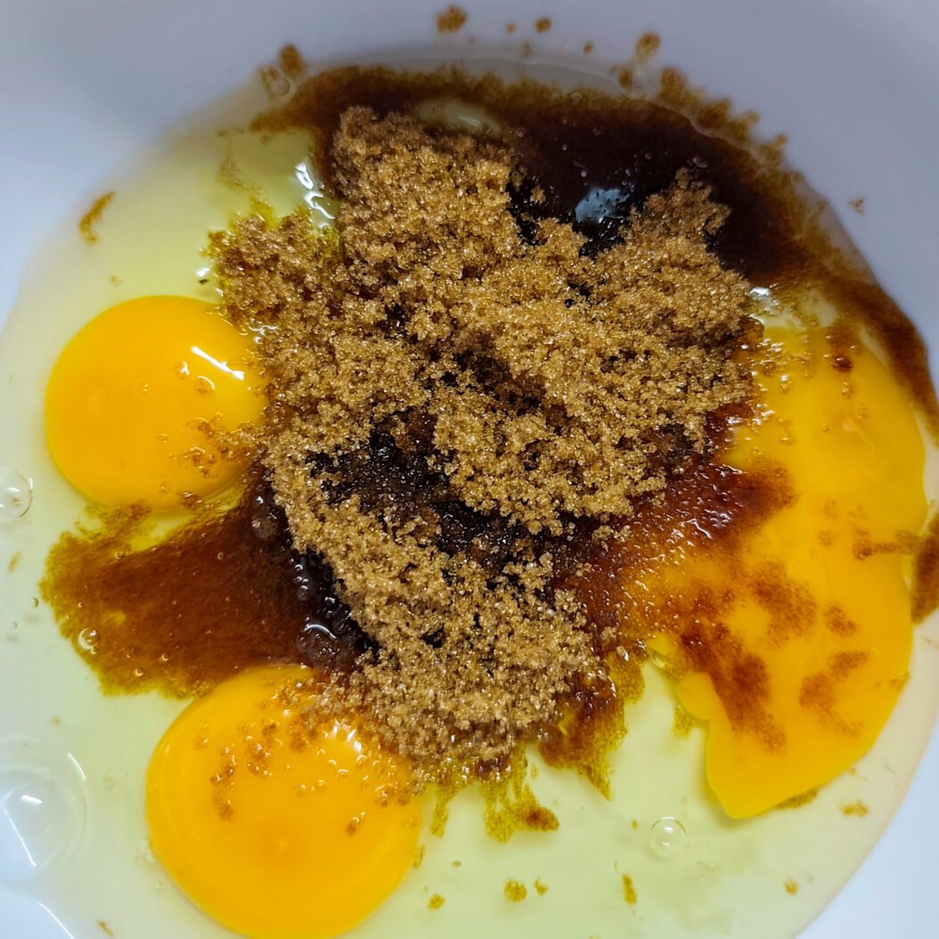 Eggs, dark brown sugar and vanilla whisked for apricot oatmeal cookies