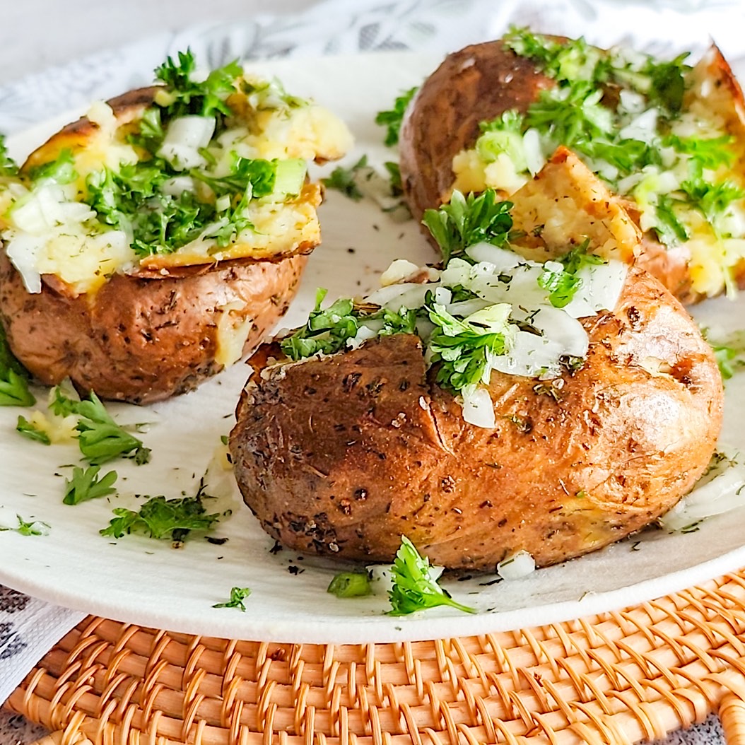 Crispy jacket potatoes filled with butter and fresh herbs.