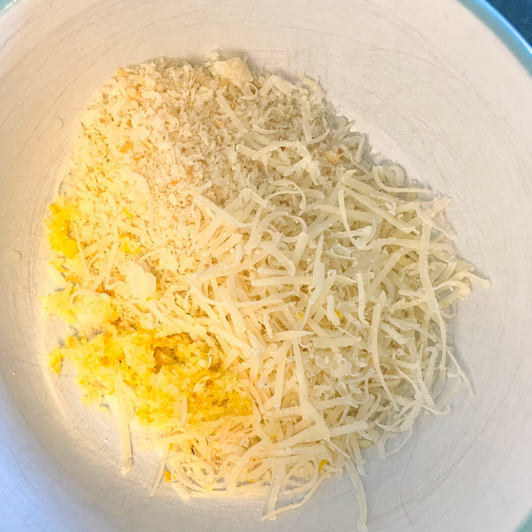 Bowl of freshly grated parmesan, breadcrumbs and lemon zest for roasted courgettes topping