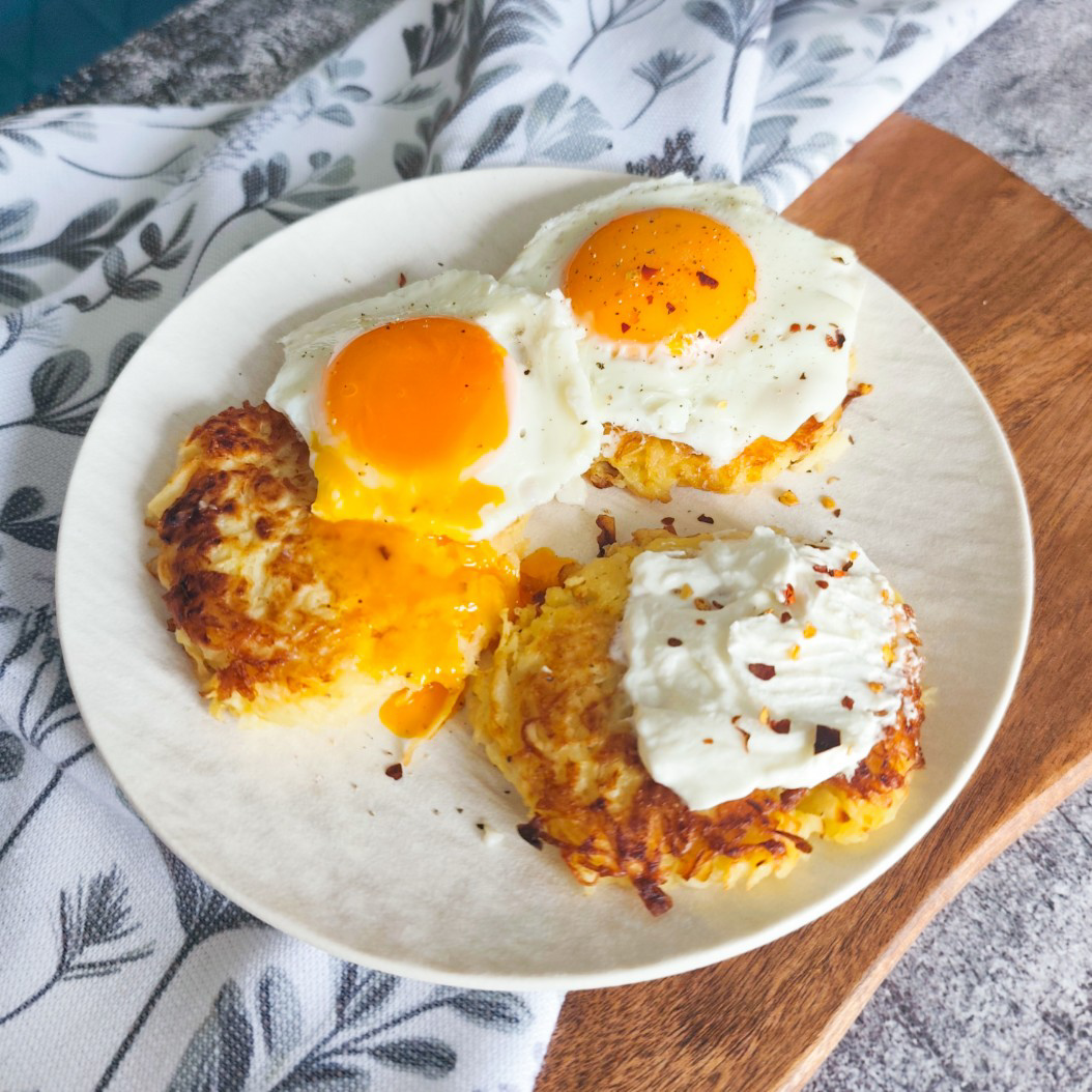 Crispy celeriac rösti topped with sunny-side-up eggs and chili flakes