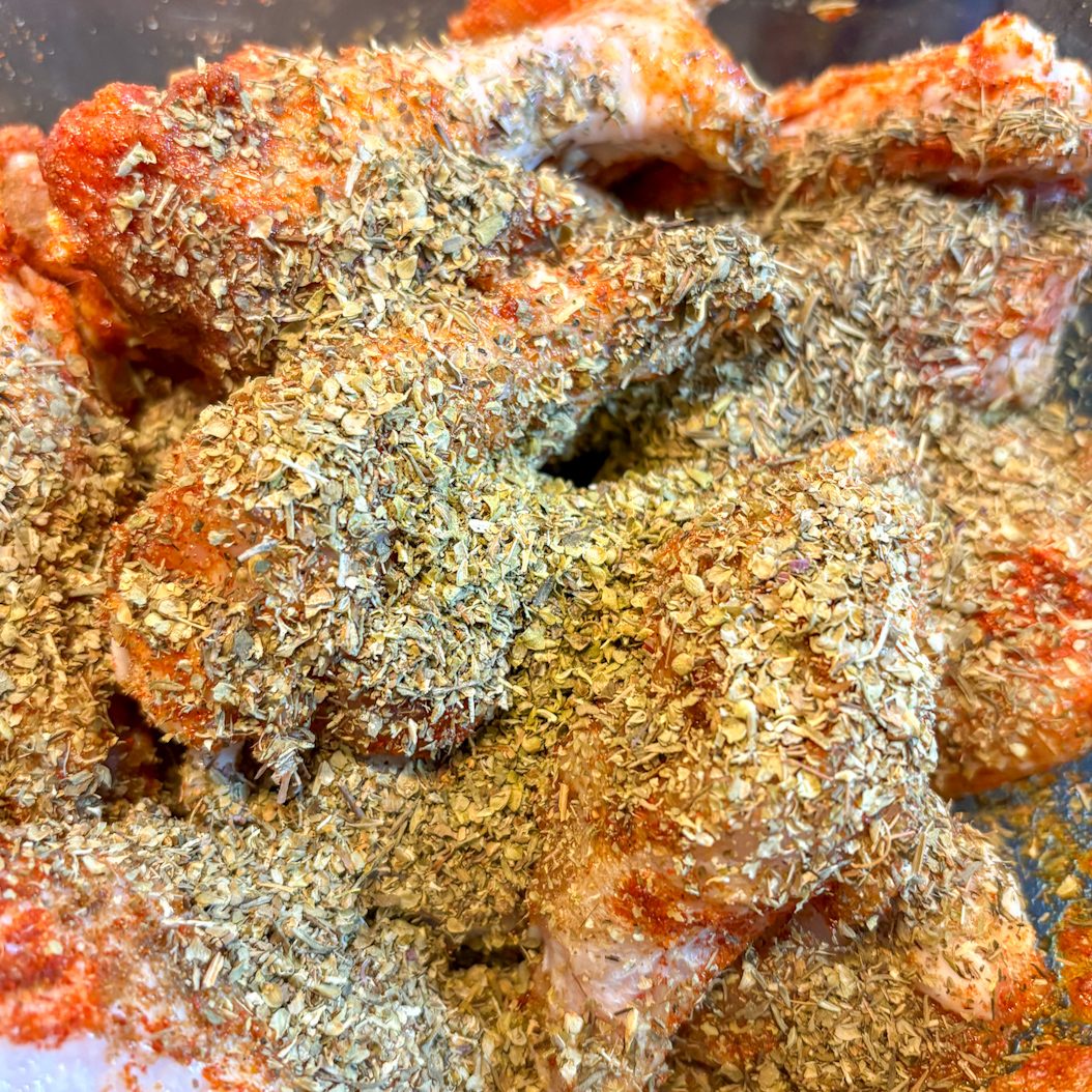 Chicken wings covered in dried thyme and oregano as part of Creole Chicken Wings spice blend.