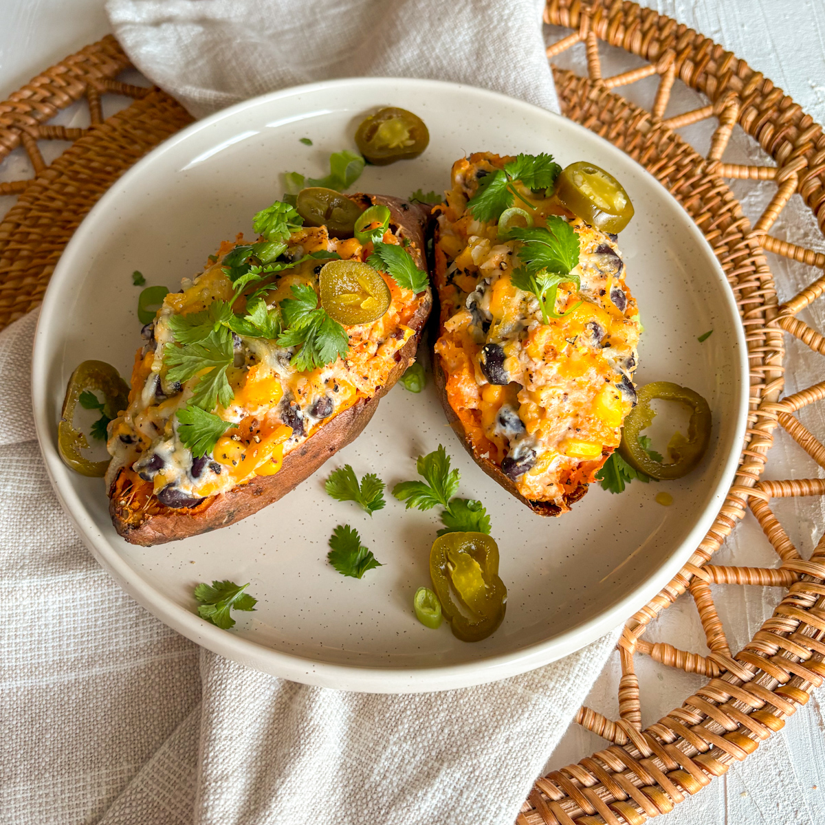 Cheap and affordable loaded sweet potatoes with black beans, corn and melted cheese topping