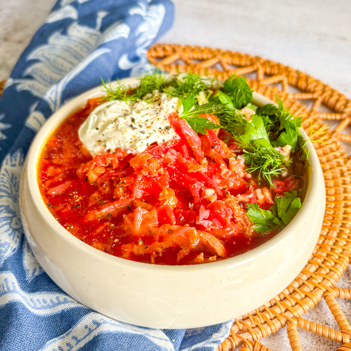 Traditional Chicken Borscht served in a white ceramic bowl with fresh parsley and a vibrant red broth.