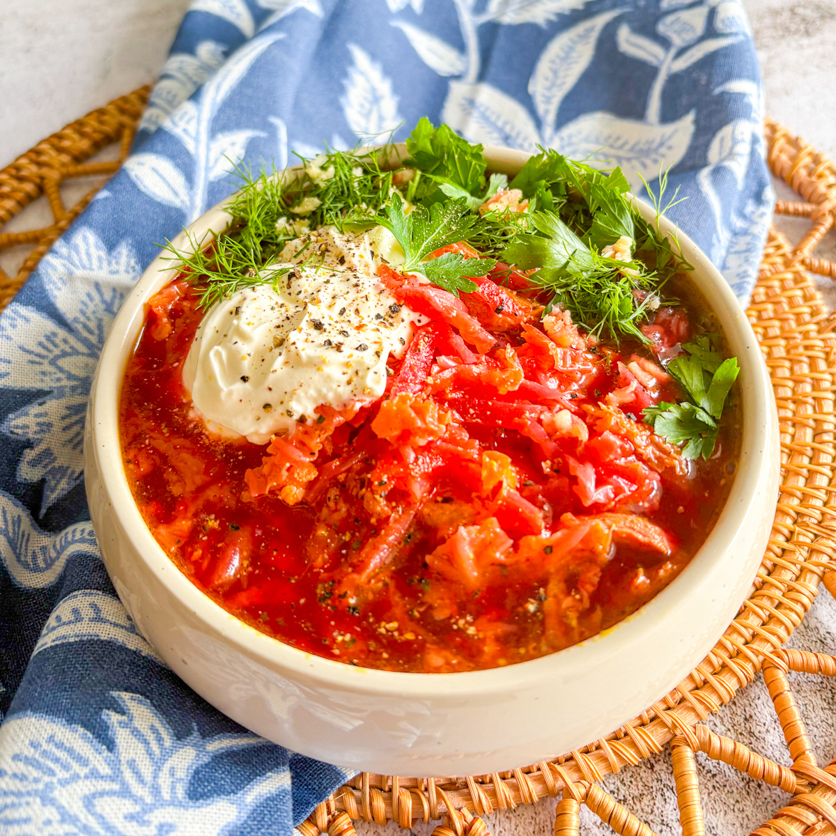 Chicken borscht with sour cream and fresh dill, vibrant beetroot and chicken soup in a rustic bowl.