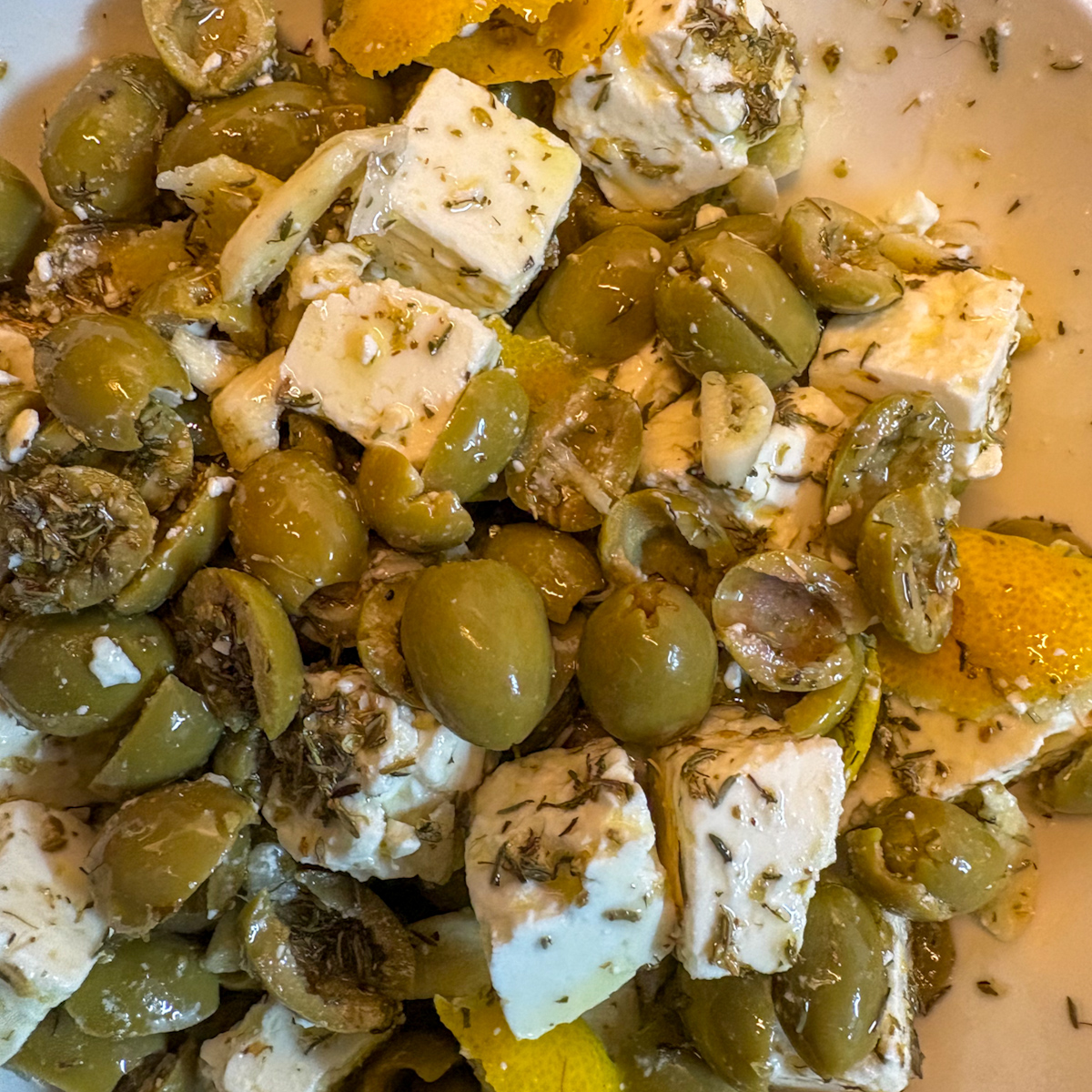 Feta and olive appetiser mixed with olive oil and Mediterranean herbs
