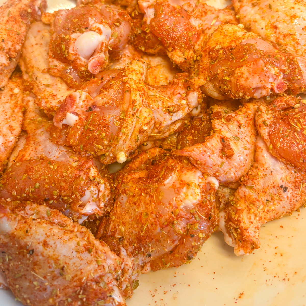 Raw chicken wings coated in fragrant spice rub for the pantry staples chicken wings recipe.