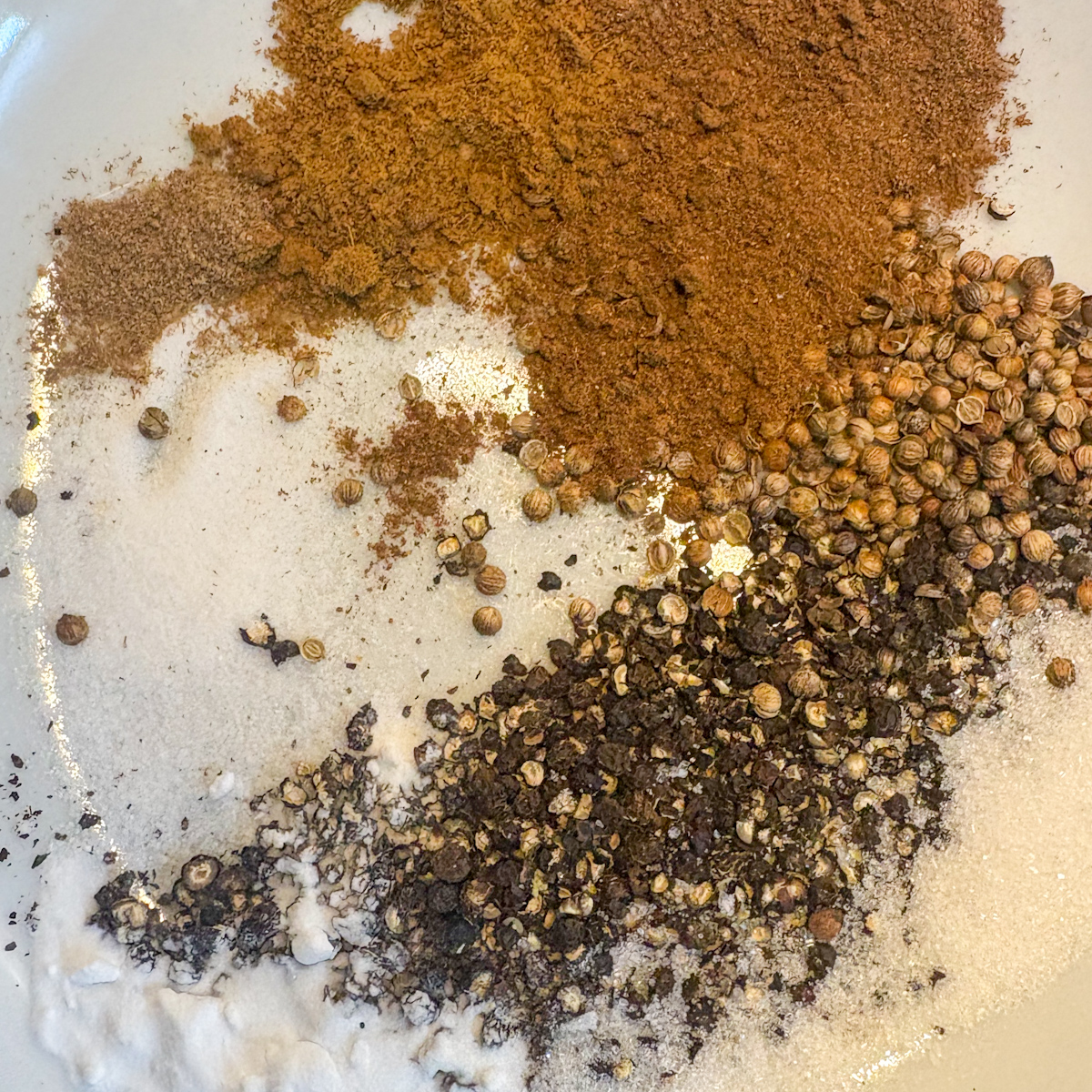 Smashed peppercorn and coriander dry rub with Chinese 5 spice, cumin and bicarbonate of soda in a bowl.