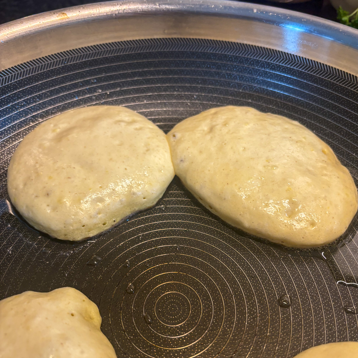 Frying fluffy ricotta pancakes in a non-stick pan until they reach a golden-brown finish.