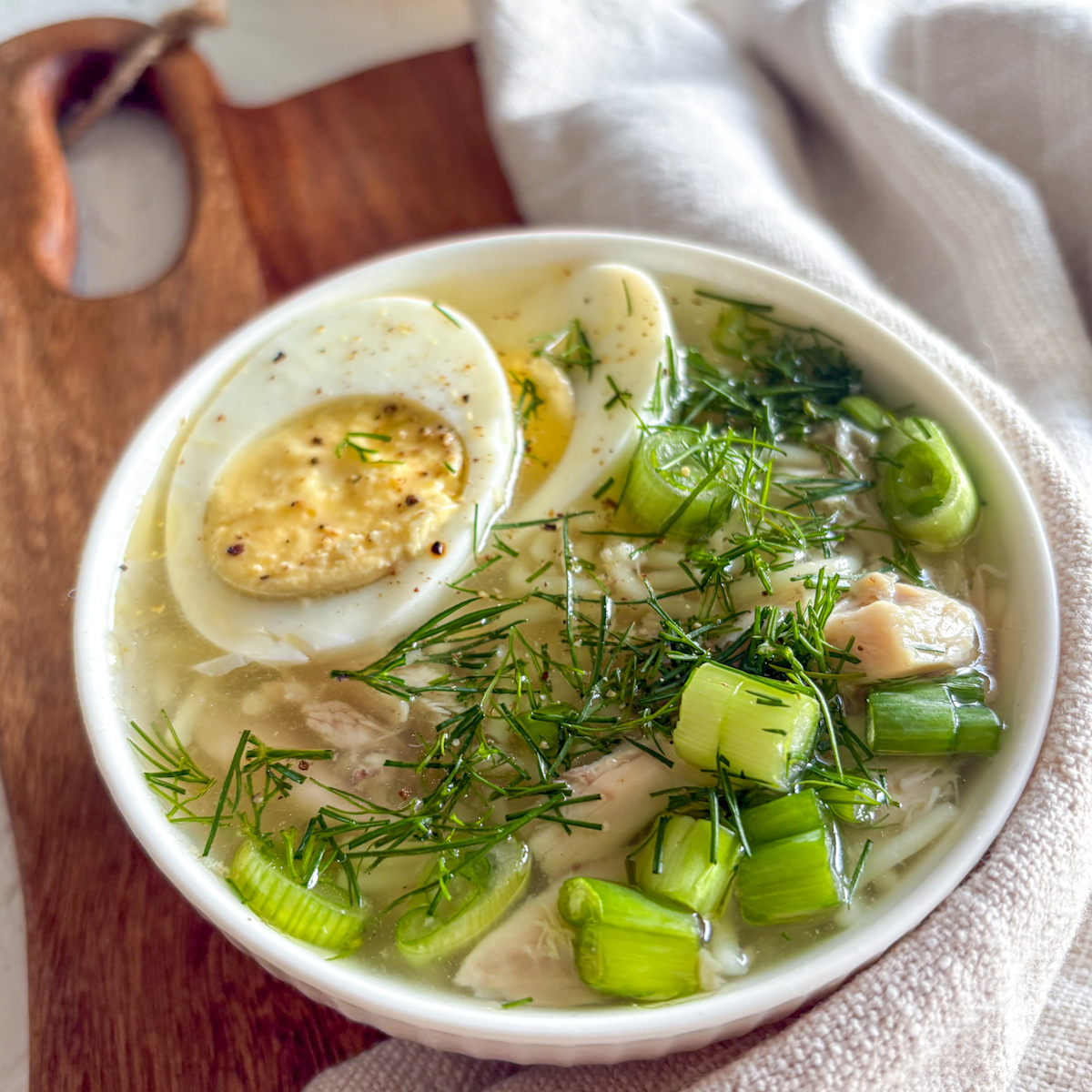 Top down view of Russian chicken soup with shredded chicken and noodles