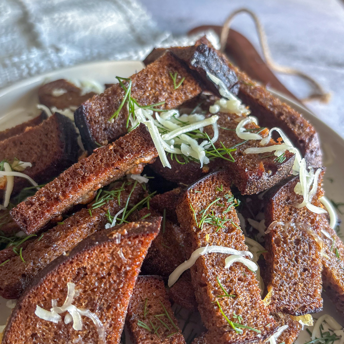 Macro shot of the crunchy texture and aromatic garlic on Homemade rye croutons.