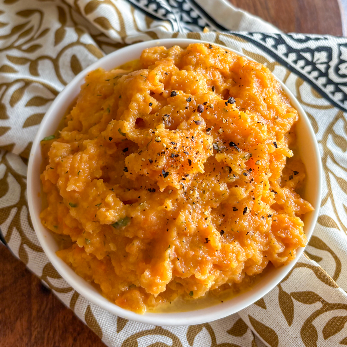 Homemade carrot and turnip mash with double cream and herb butter