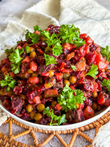 Classic vinaigrette salad with peas and pickles in a shallow bowl