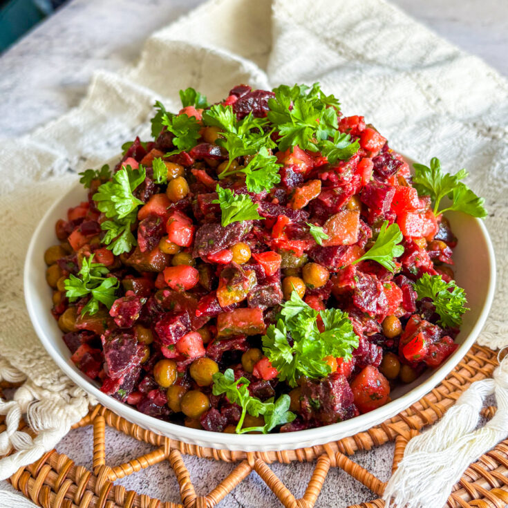 Classic vinaigrette salad with peas and pickles in a shallow bowl
