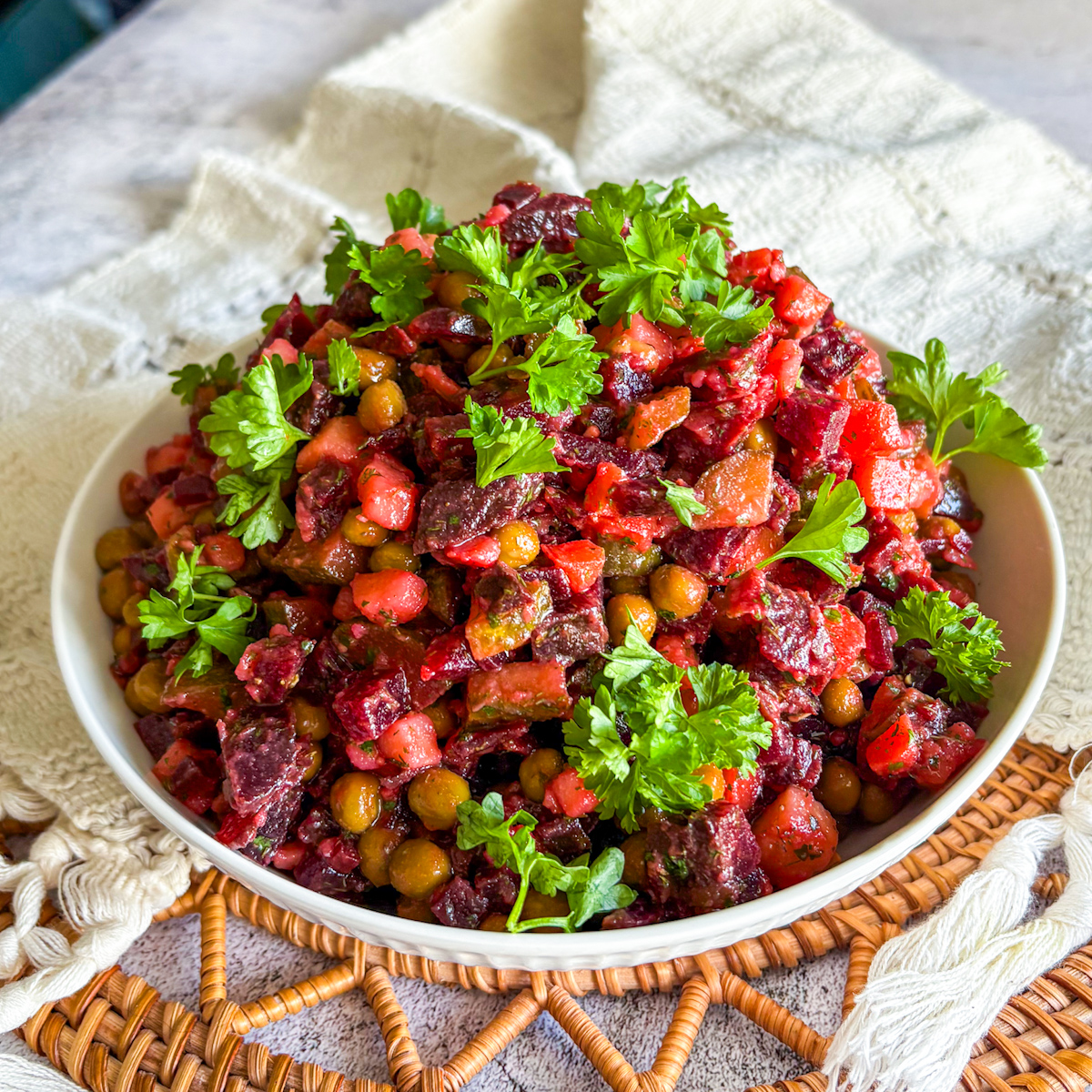Classic vinaigrette salad with peas and pickles in a shallow bowl