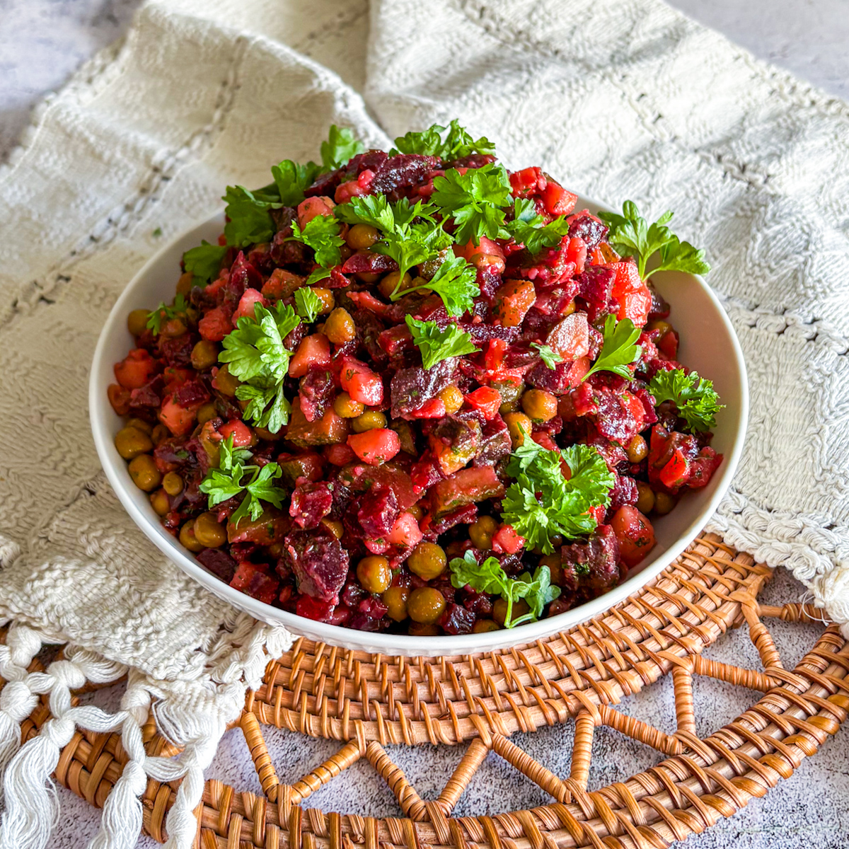 Traditional Russian beetroot salad served in a white bowl with parsley
