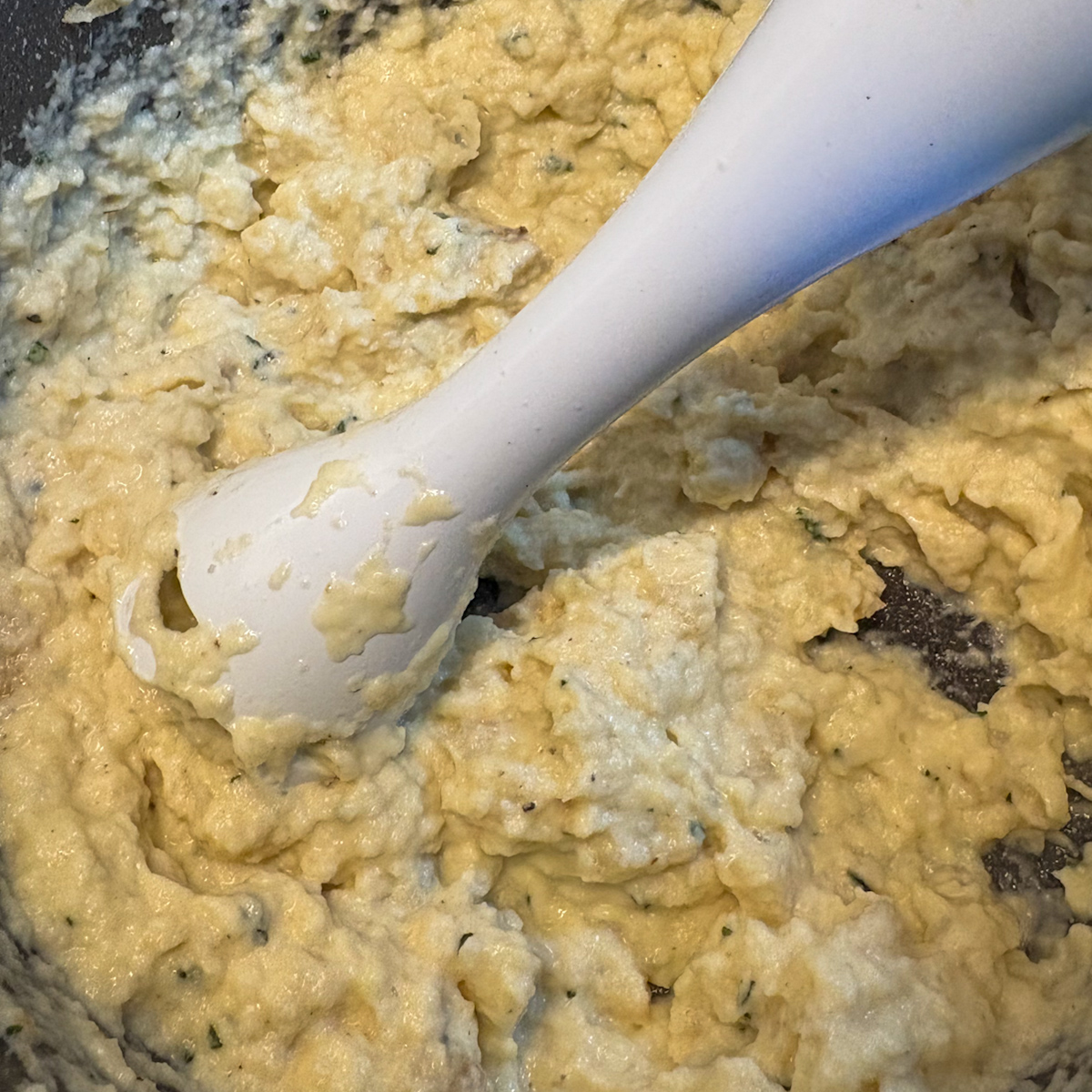 Blending celeriac purée in a pot with a hand blender