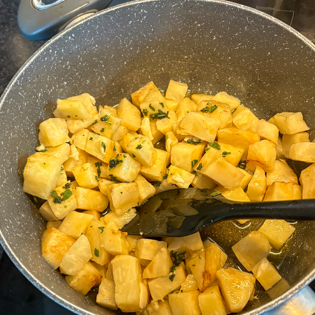 Sautéed celeriac cubes with garlic and sage for creamy celeriac purée