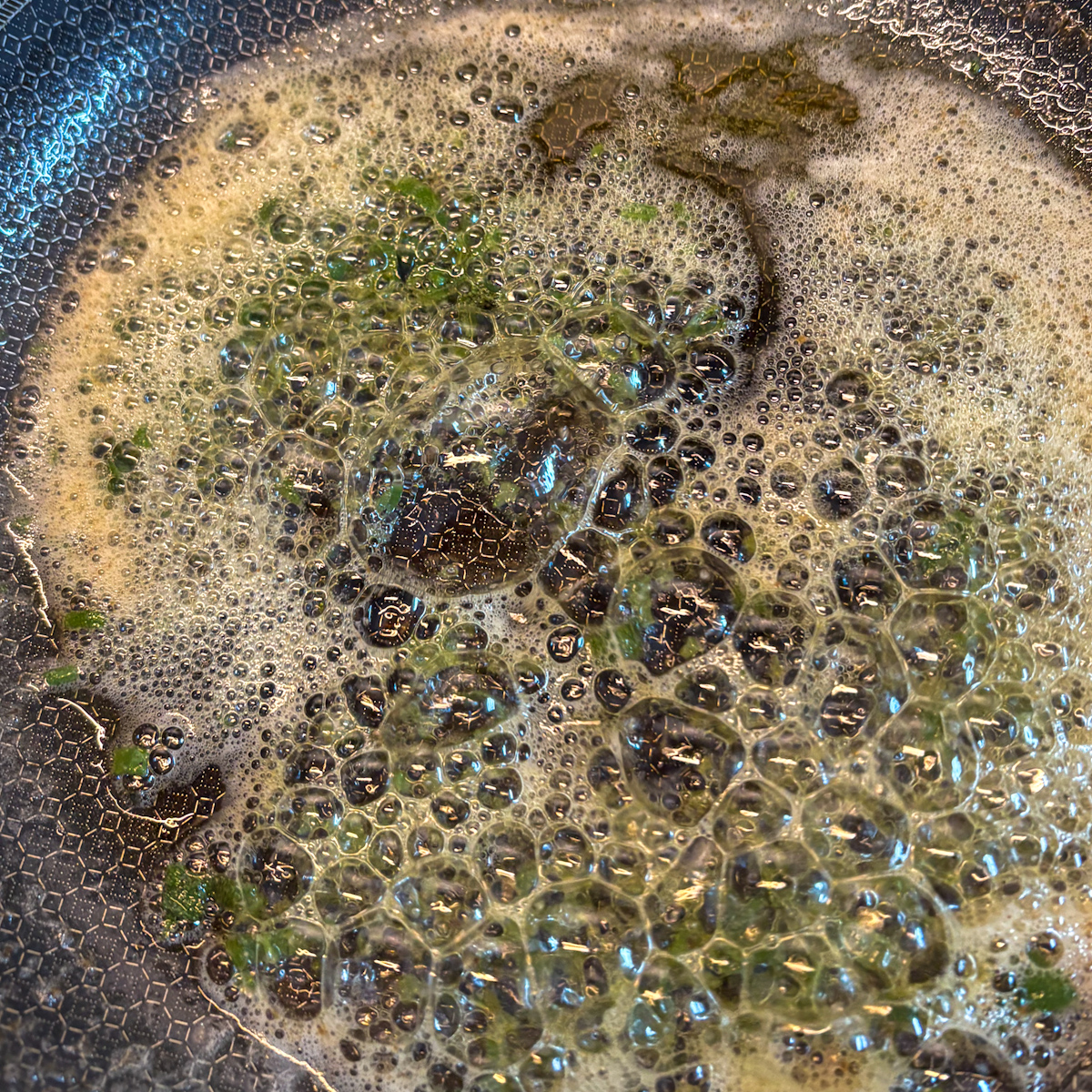 Foaming sage brown butter in a pan for celeriac purée recipe