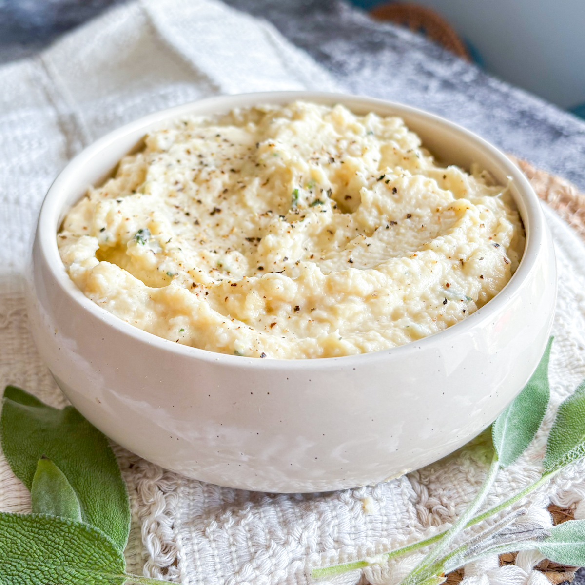Creamy celeriac mash topped with cracked black pepper and sage