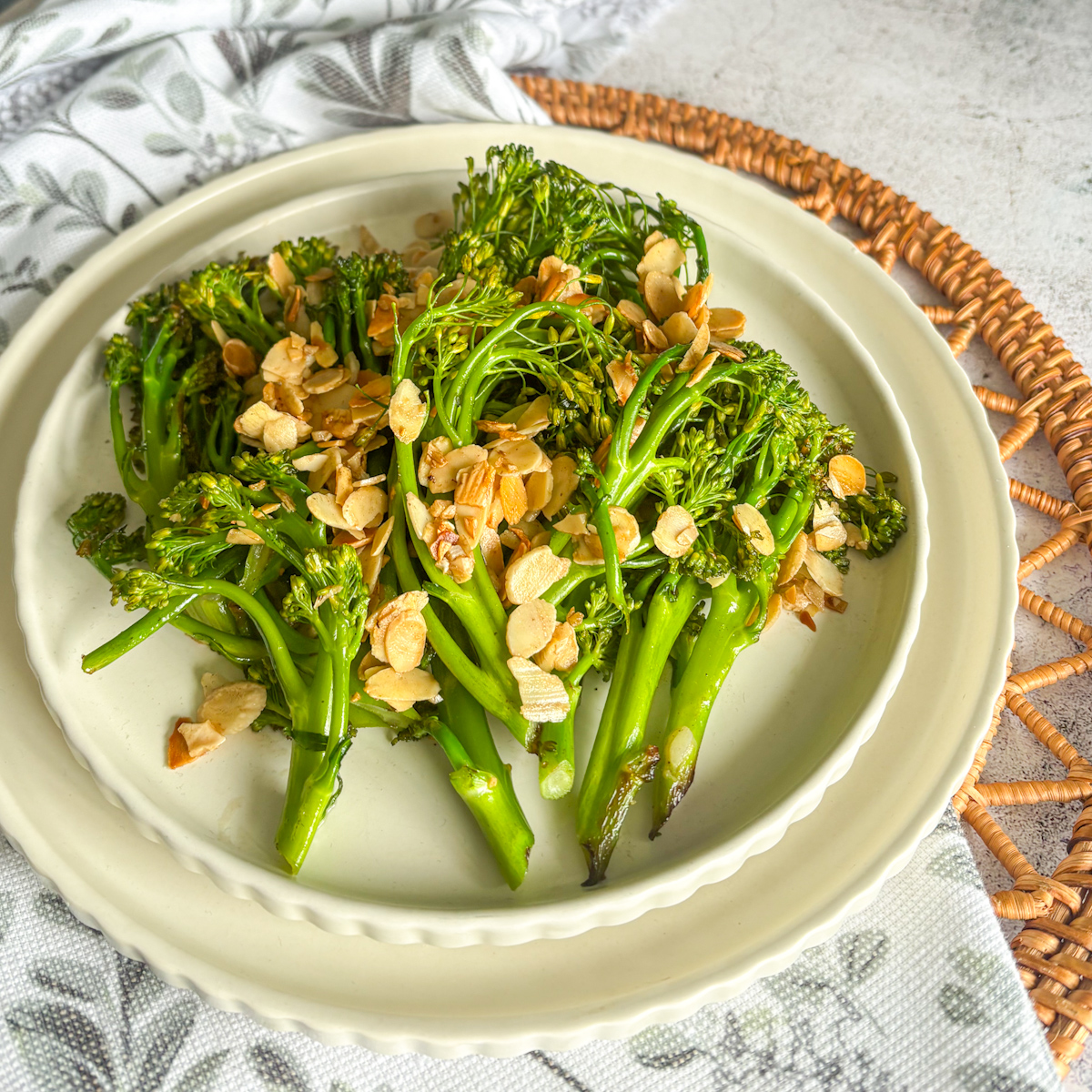 Easy charred broccolini side dish with garlicky almonds on a styled plate