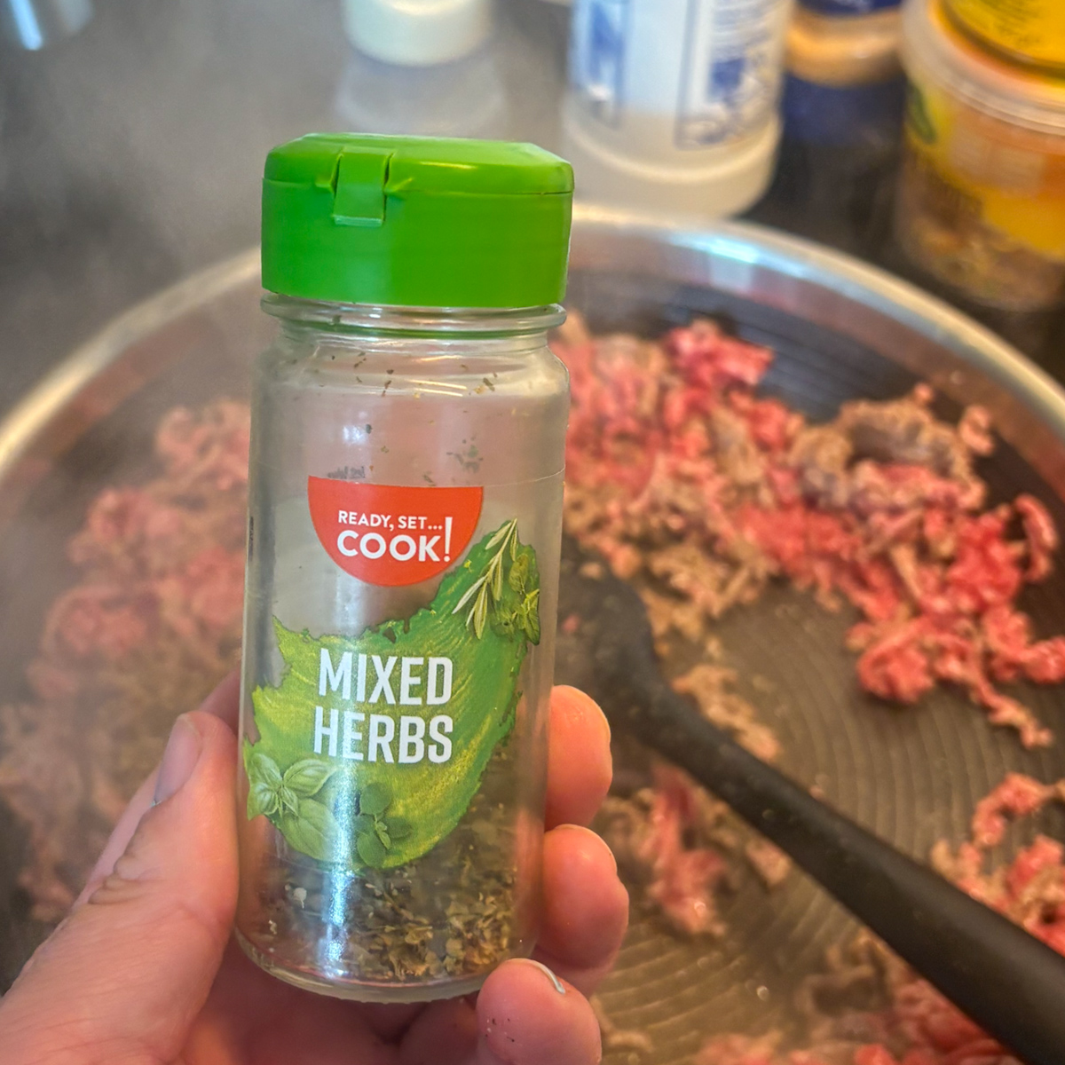 Lean beef mince breaking into crumbs in a skillet for beef and asparagus pasta recipe