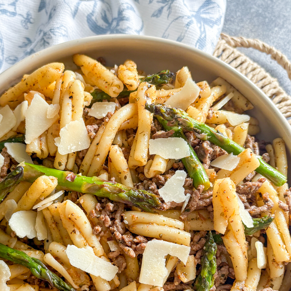 Close-up of beef and asparagus pasta with shaved parmesan, charred asparagus and dried Italian herbs