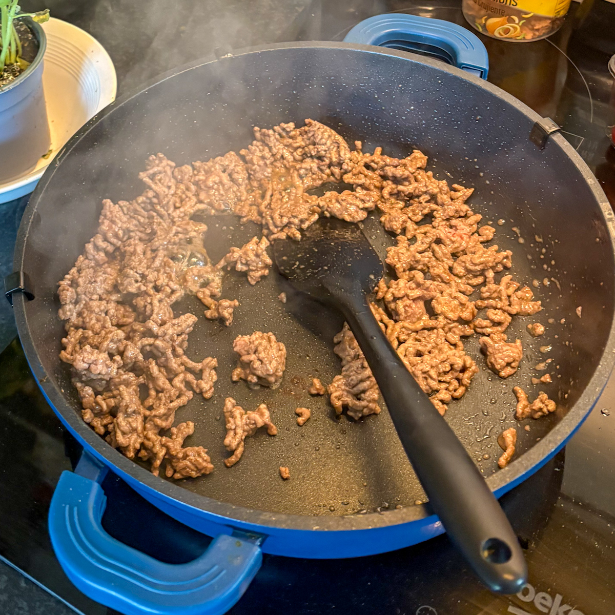 Browning beef mince in a skillet, the first step in dirty rice with beef mince