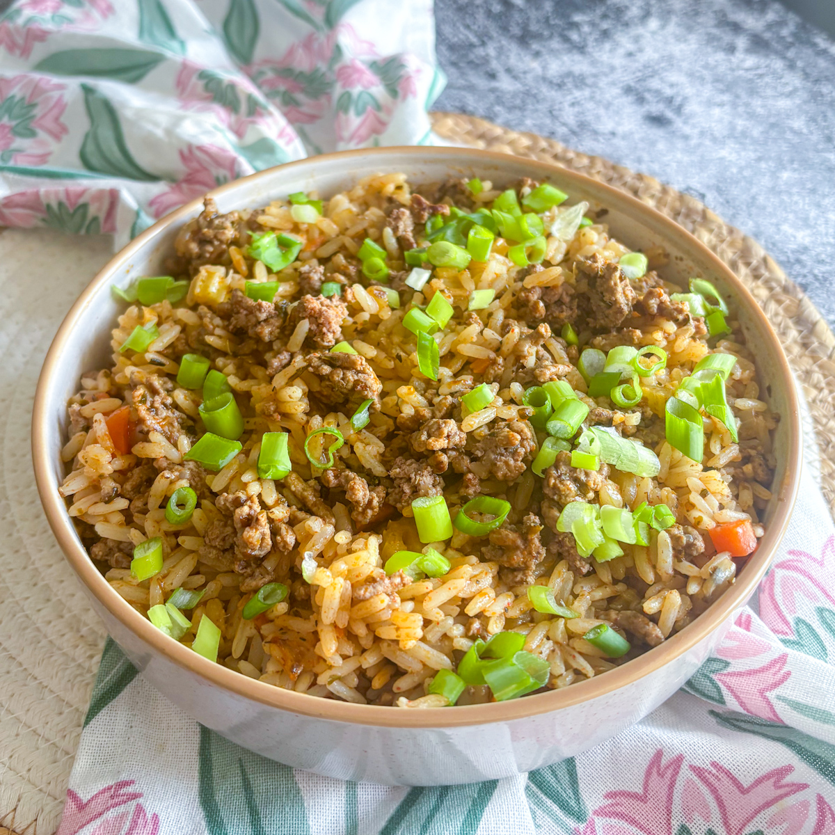 Bowl of Louisiana dirty rice with beef mince and scattered green spring onions