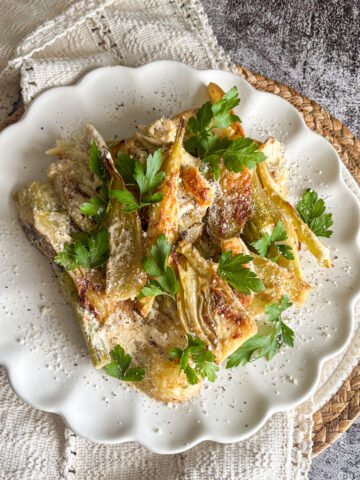 Easy baked fennel with parmesan and parsley on a white plate