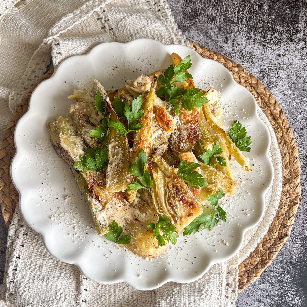 Easy baked fennel with parmesan and parsley on a white plate