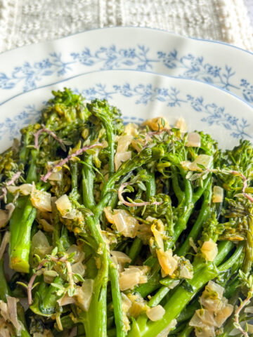 Pan-steamed broccolini with garlic and shallot served on a decorative dinner plate