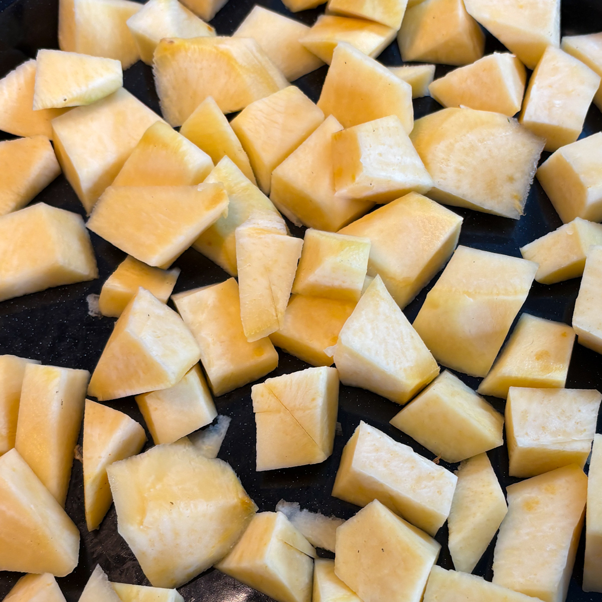 Peeled turnip cut into bite size pieces ready for oven roasted turnips
