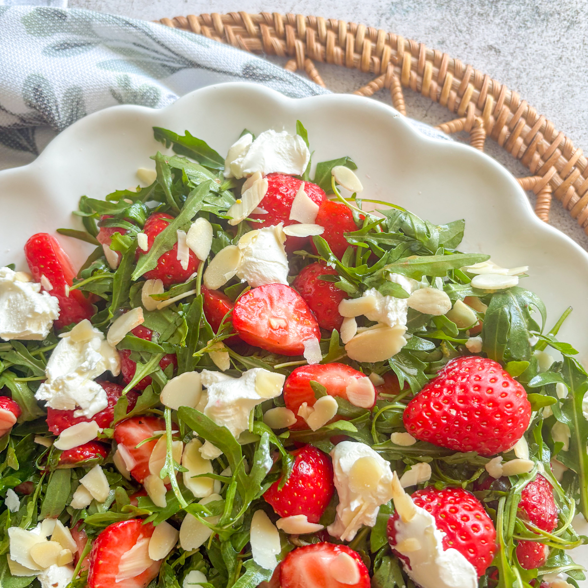 Close-up of strawberry rocket salad with juicy strawberries, mascarpone and almonds