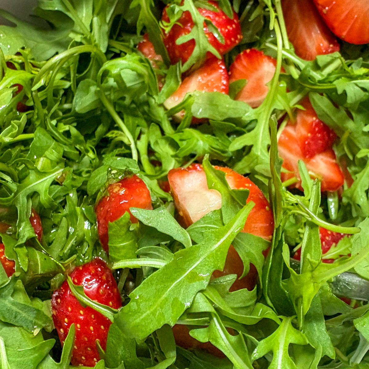 Tossed strawberry rocket salad with strawberries and rocket before adding mascarpone