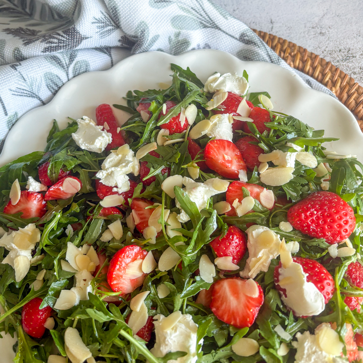 Strawberry rocket salad close-up with strawberries, mascarpone and toasted almonds