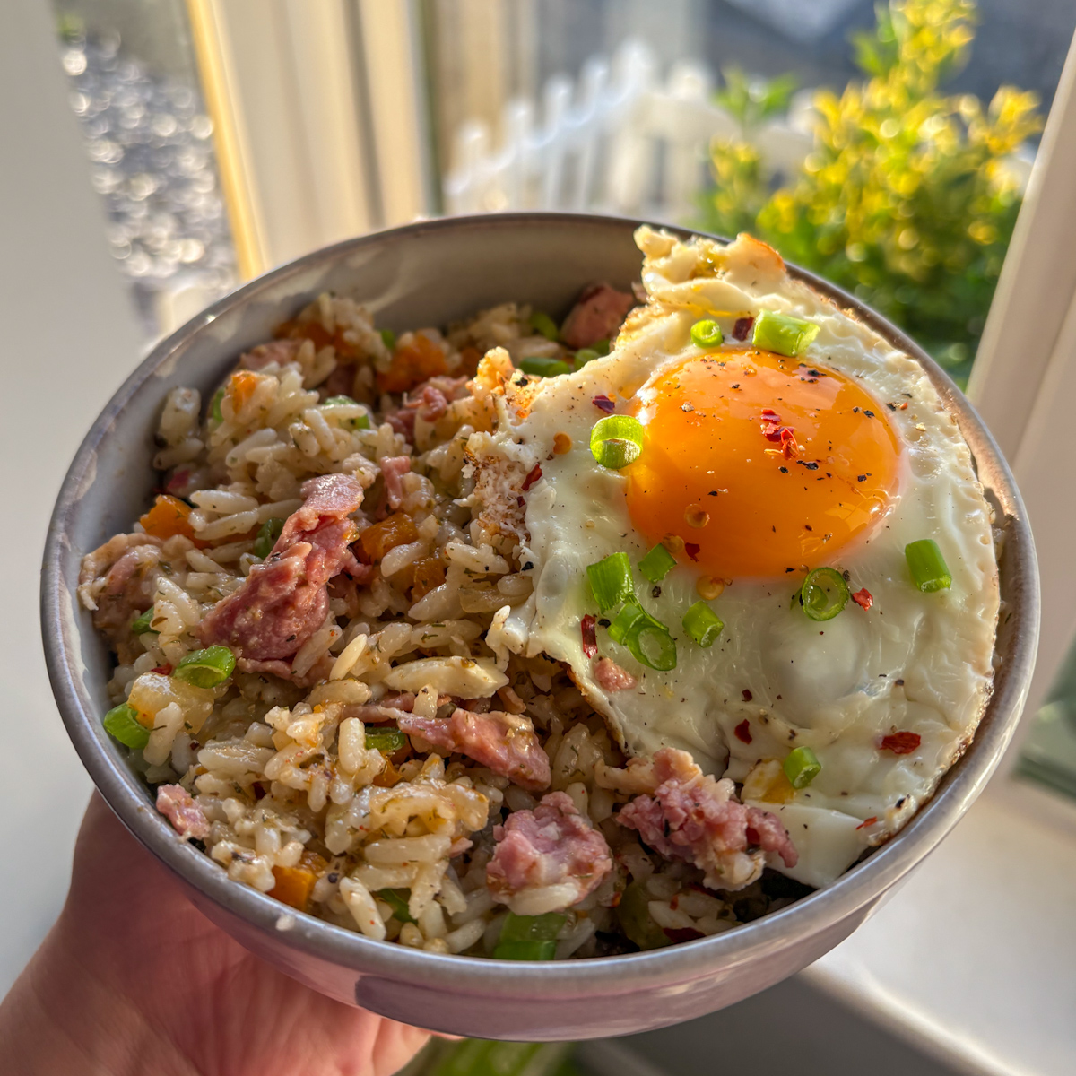  Breakfast dirty rice with crispy bacon, spring onions and a golden fried egg