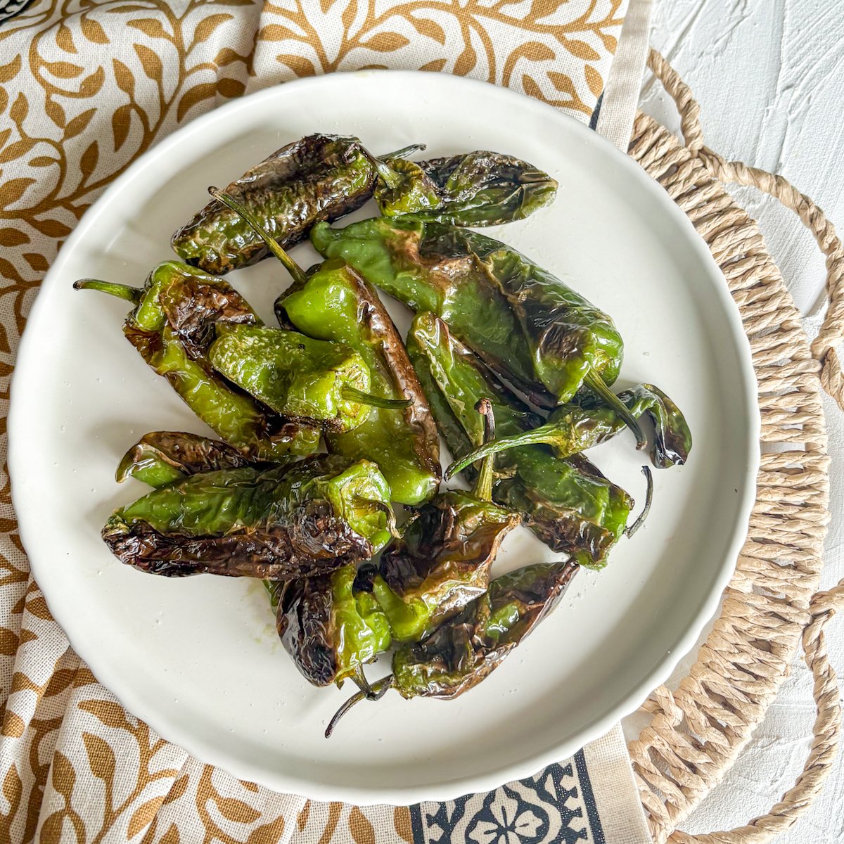 Padron peppers tapas served hot on a white plate