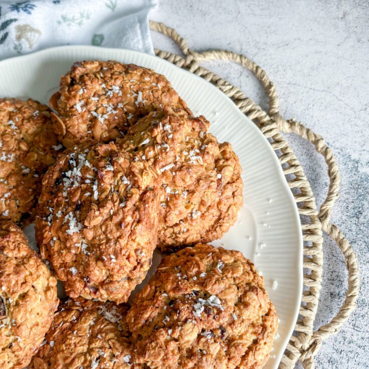 Soft and crunchy oatmeal cookies with dates served on a white plate over a floral napkin