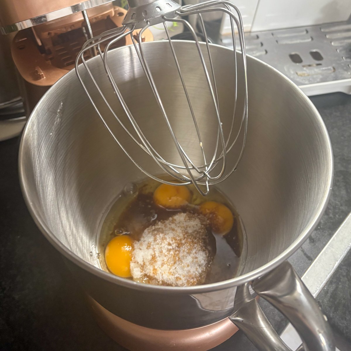 Eggs and sugar in a stand mixer bowl, the first step for oatmeal cookies with dates