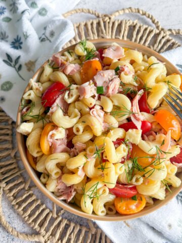 Refreshing pasta salad with dill vinaigrette, tomatoes clustered around the bowl