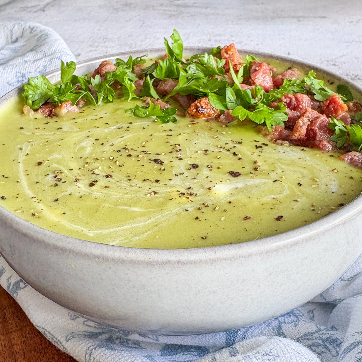 Pea and bacon soup from above, crispy bacon and parsley on silky green soup