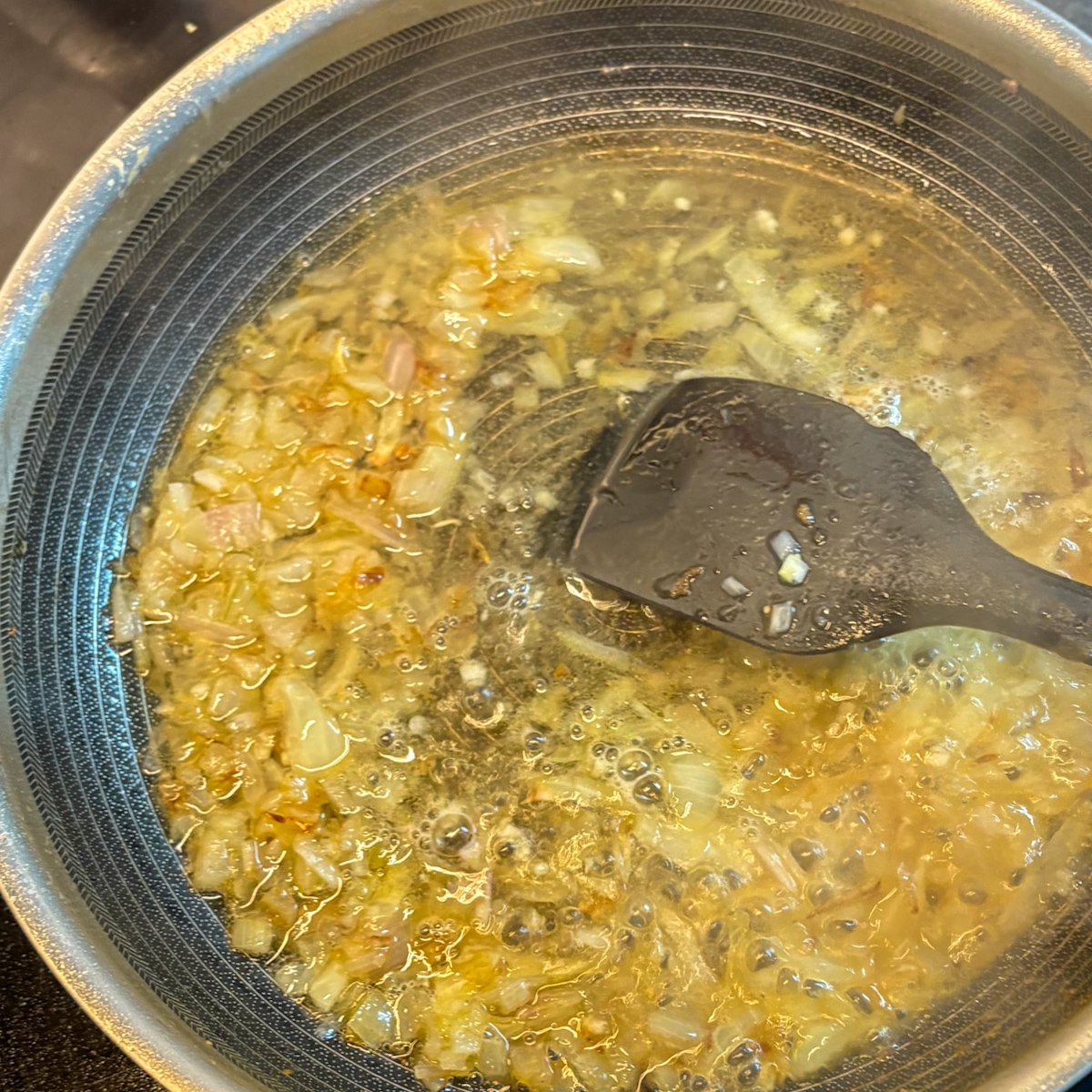 Onion and shallot softening in bacon fat — cooking peas with bacon and ricotta
