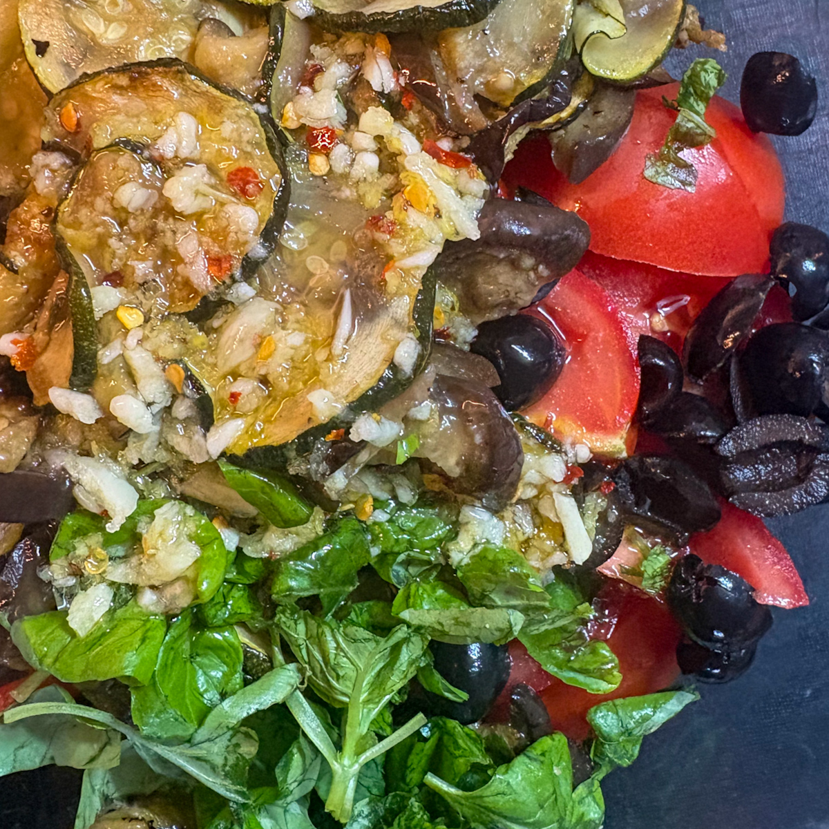  Roasted courgette and aubergine salad tossed in garlicky lemon dressing with olives and basil
