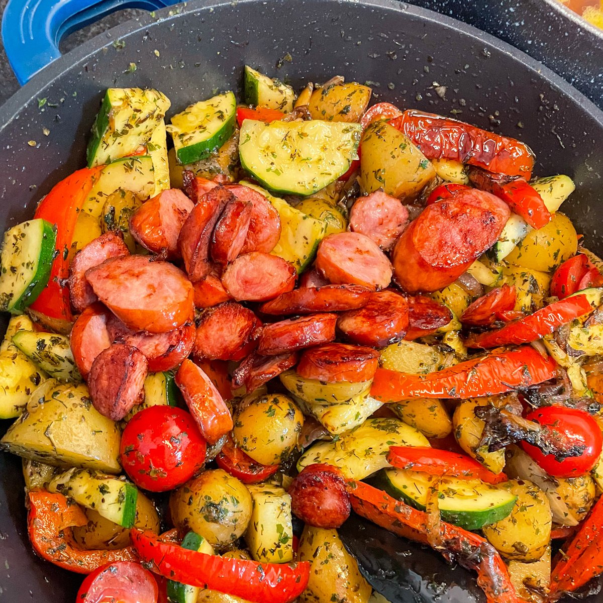  Sausage and vegetable stew cooking in a skillet with kielbasa, potatoes, courgette and peppers