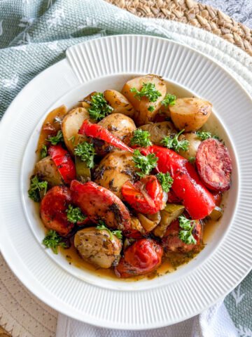 Summer sausage and potato stew with kielbasa, sweet peppers and courgette in a herby broth