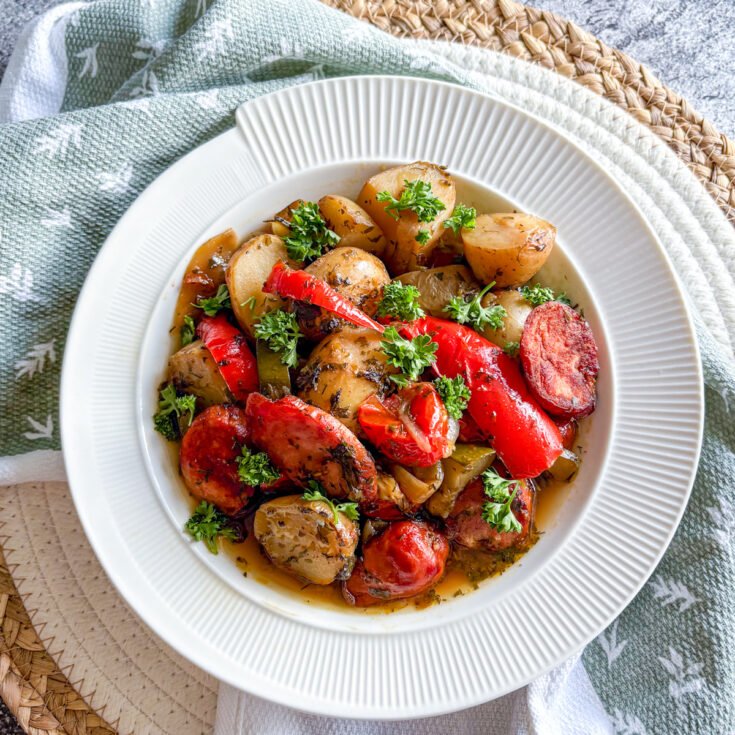 Summer sausage and potato stew with kielbasa, sweet peppers and courgette in a herby broth