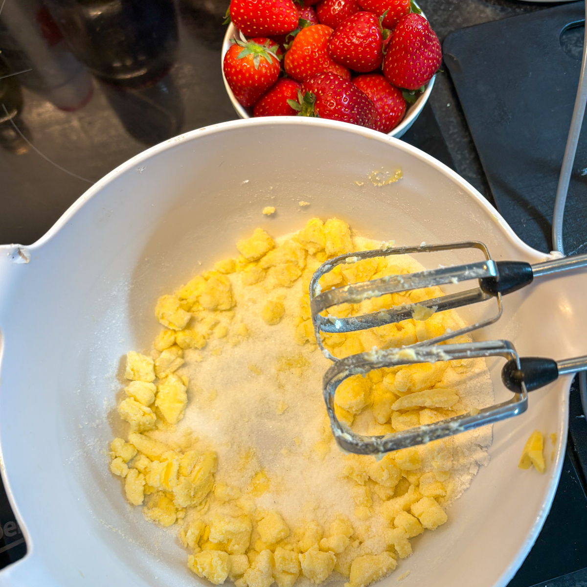 Rubbing butter and sugar in a bowl to start strawberry oatmeal cookies
