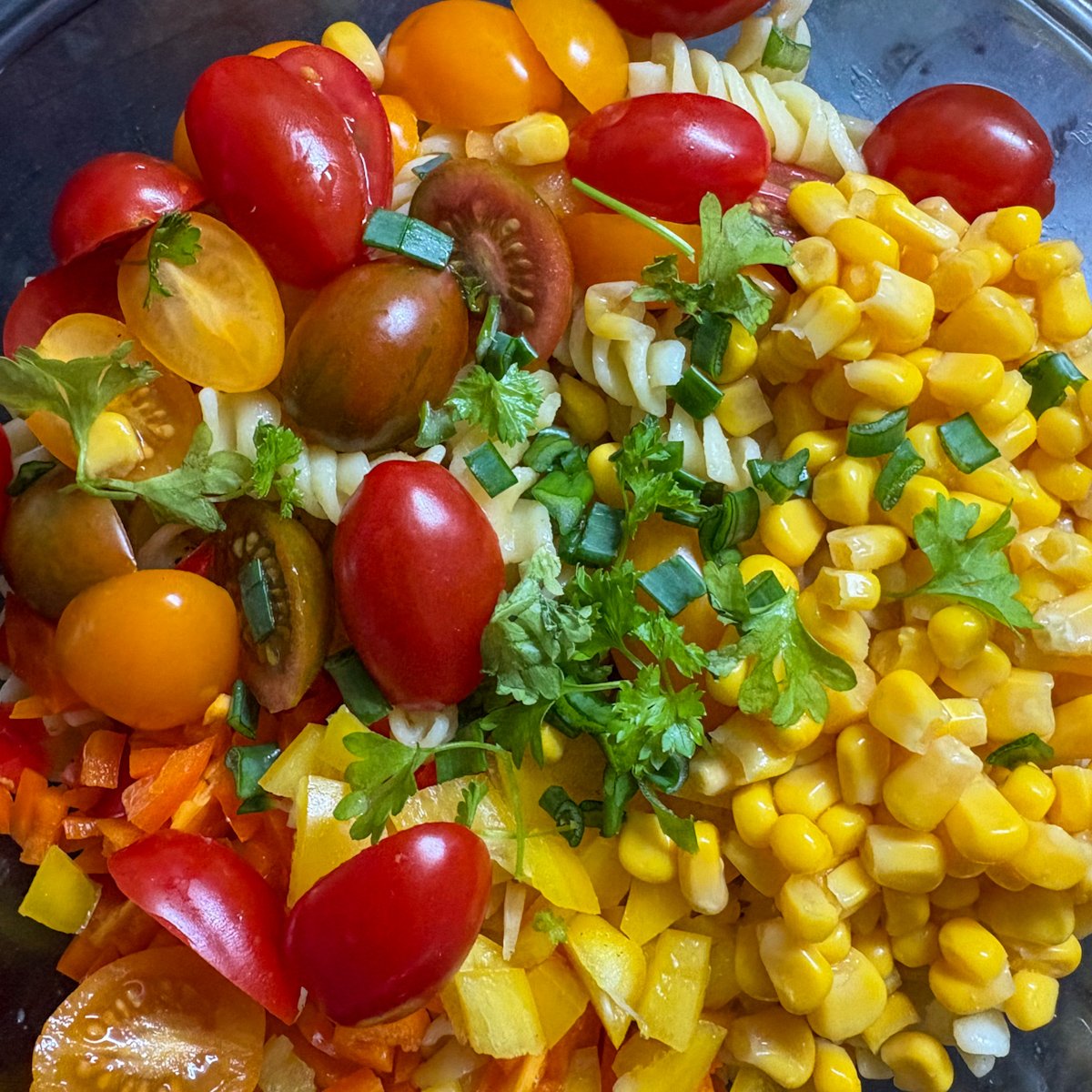 Chopped cherry tomatoes, sweetcorn and peppers prepped for summer pasta salad recipe